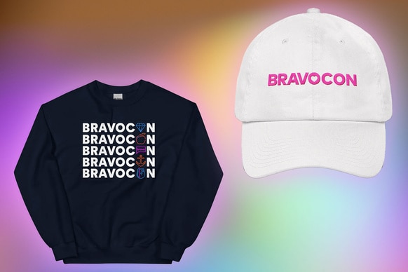 A sweatshirt and baseball cap that say Bravocon on a pastel rainbow background.