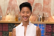 Kristen Kish wearing a white top in Top Chef kitchen.