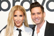 Tracy Tutor and Josh Flagg standing in front of a step and repeat at BravoCon 2023.