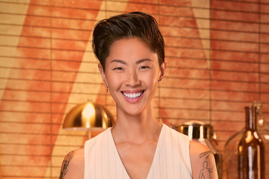 Kristen Kish wearing a vest in a kitch pantry