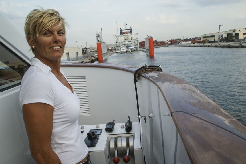 An old photo of Captain Sandy Yawn with short hair standing on a boat