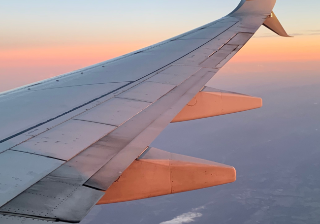 Photo of airplane wing in the sky