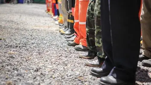 Various emergency response workers standing in line with one another