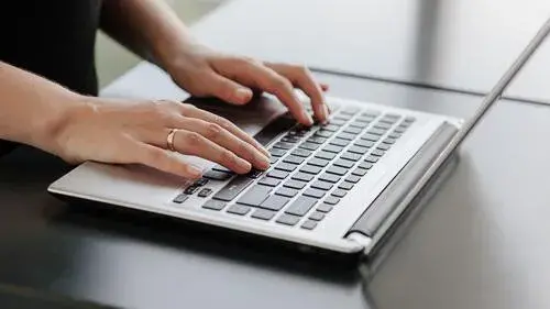 hands typing on a keyboard