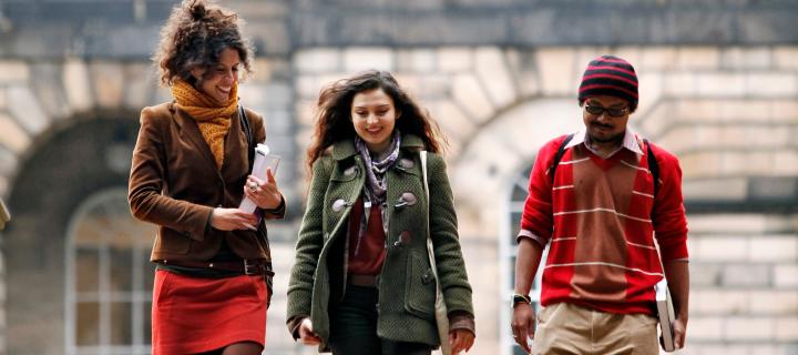 Three students walking down the steps at Old College Quad