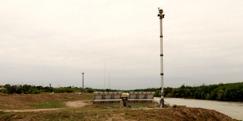 Two CBP surveillance towers along the Rio Grande