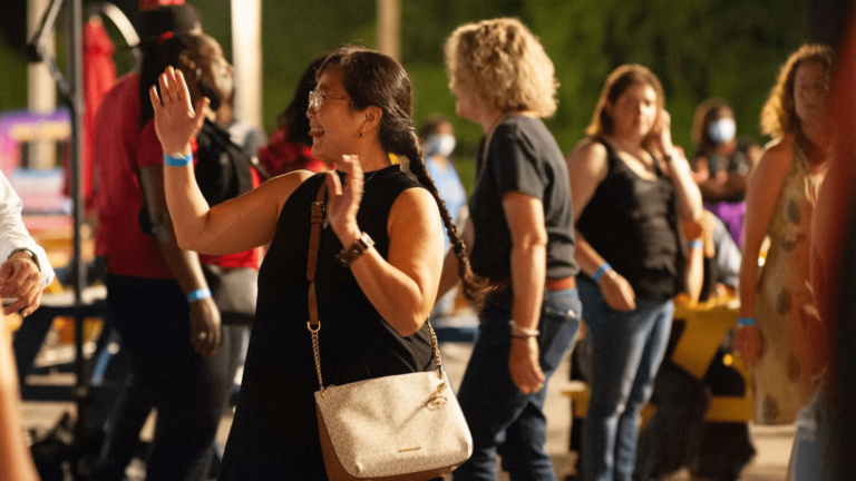 woman dancing in front of queue