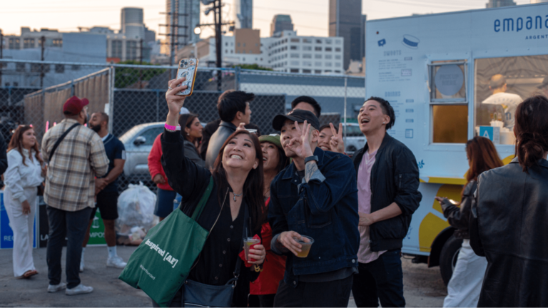 Event attendees in front of a food cart