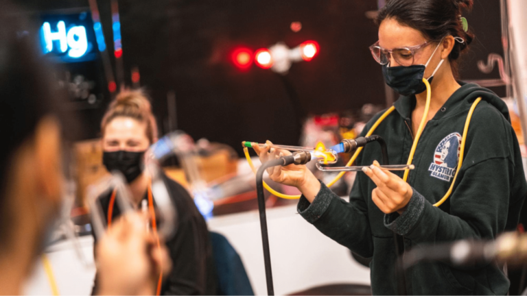 A person using safety equipment at a glassblowing workshop