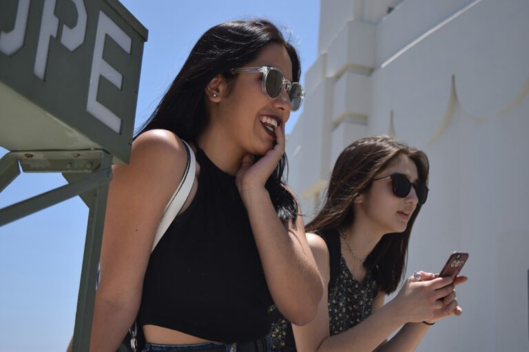 Two women at an event in the sunshine