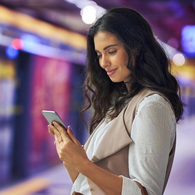 Image of woman using mobile phone outdoors