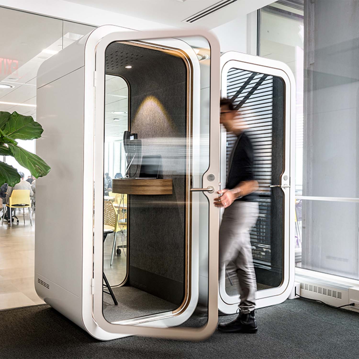 Person stepping into a Framery O office phone booth in Datadog offices.