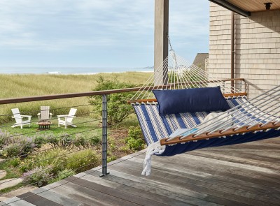 Backyard view with a striped hammock.