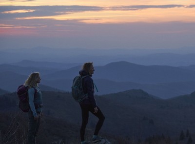 Two women hiking at sunset