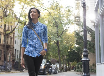 Woman walking down city street