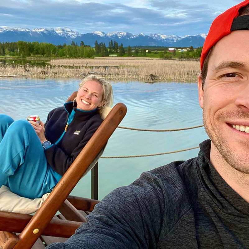 A selfie taken by Jessie's friend, Jessie sitting in a deck chair by the water, her friend's face half in the shot.