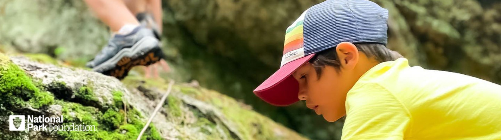 Young boy climbing on rocks