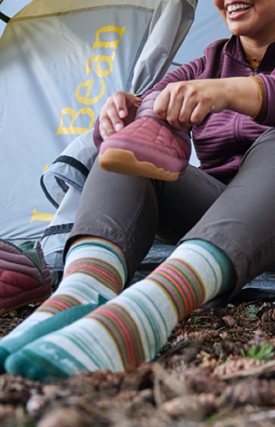 Image depicting a person wearing socks while camping.