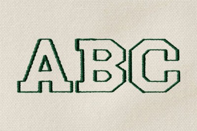 The letters "ABC" monogrammed in green thread in Athletic font on cream-colored canvas.