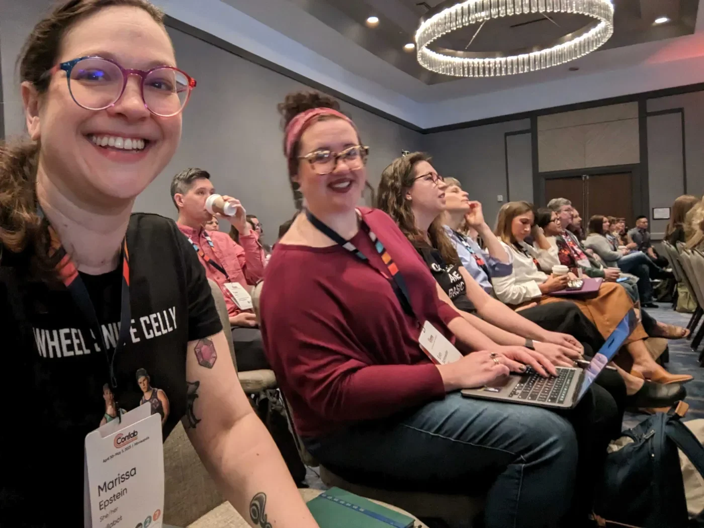 Lullabot team members at Confab sitting in a room waiting for a session to begin.