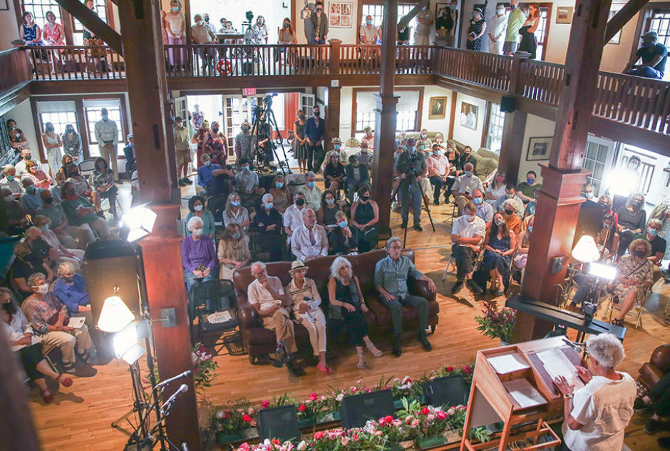 Overhead shot of audience and speakers inside Bond Hall