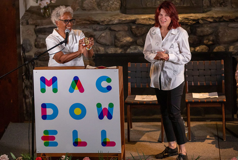 Nell Painter presents Roseanne Cash with Edward MacDowell Medal on stage in Bond Hall