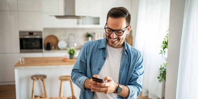 Stock image of a man looking at his phone