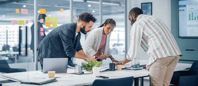 A diverse team collaborates over a conference table