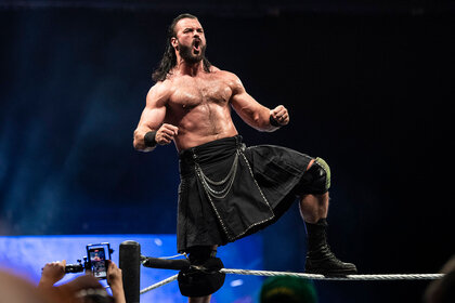 Drew Mcintyre stands on the top of the ropes