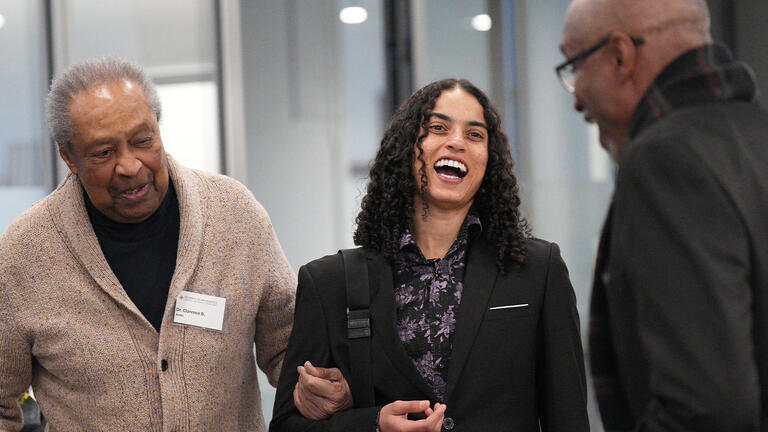 Dr Clarence B. Jones talking to attendees