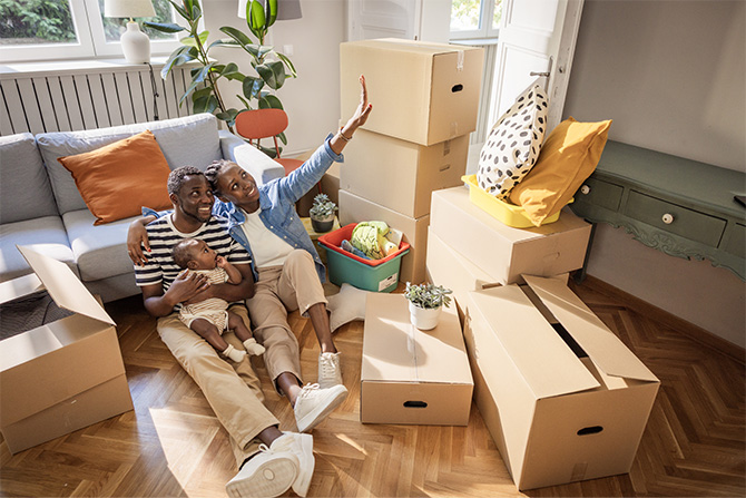 A family sitting among moving boxes together.