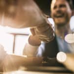 Close up of two businessmen shaking hands after successful agreement.